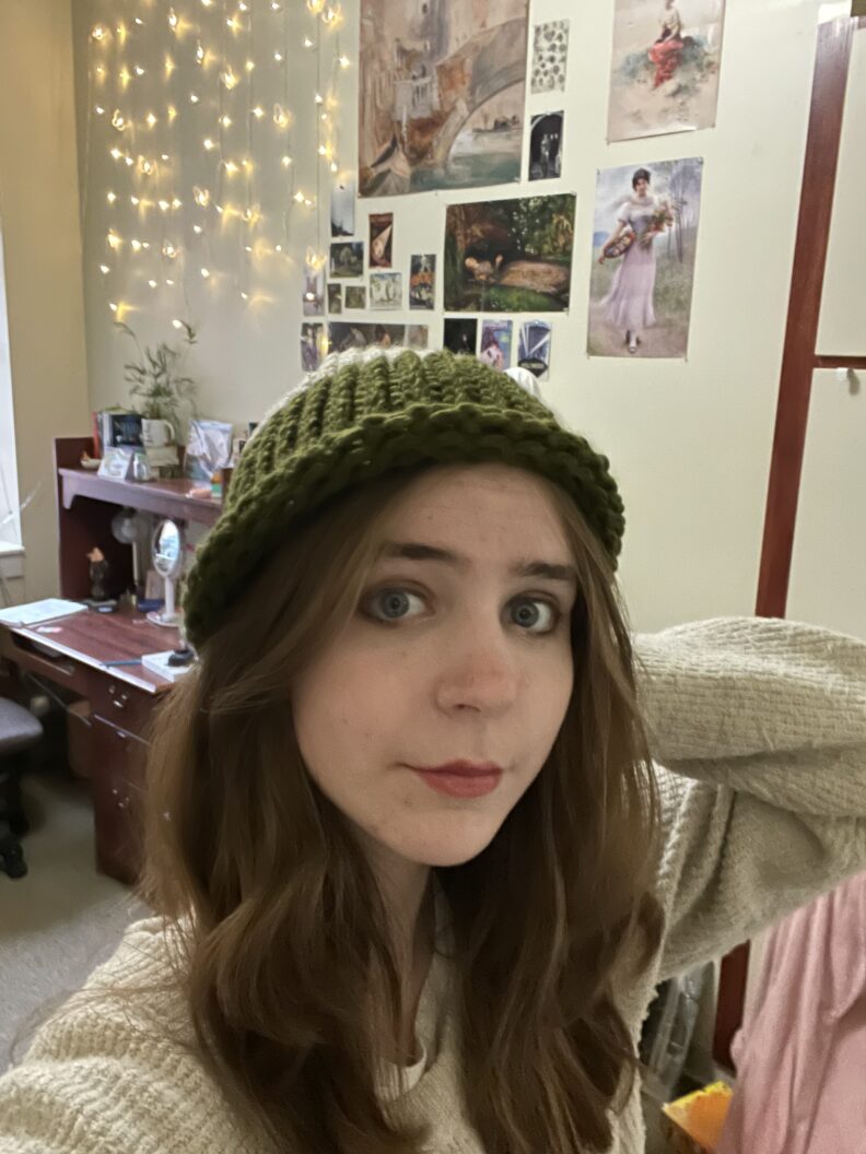 Selfie of OL Ember in a green knit hat and oatmeal sweater