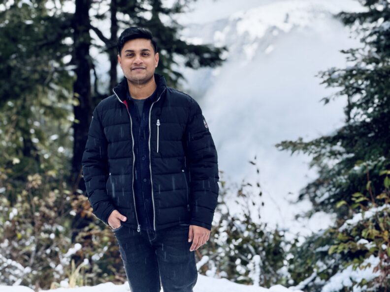 OL Jubayer stands in the snow smiling