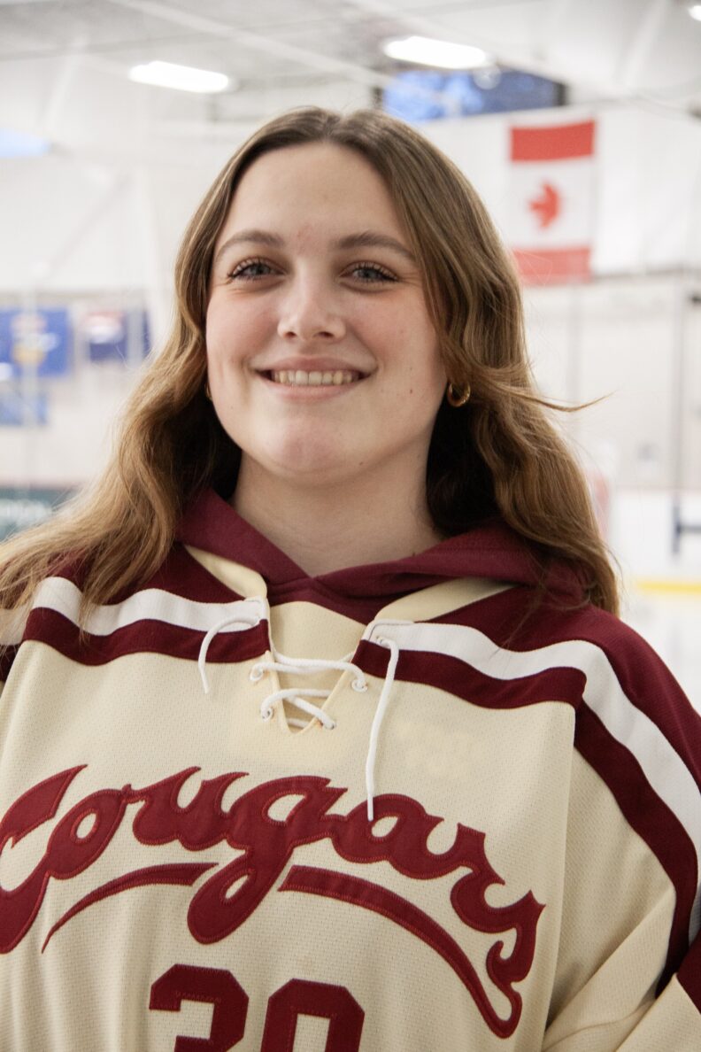 OL Kianna smiles in a hockey style Cougars shirt