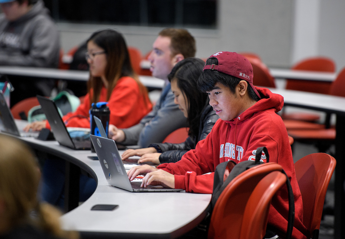 Student working on laptop during class