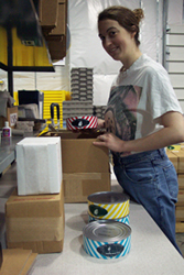 A photo of someone packaging cheese.
