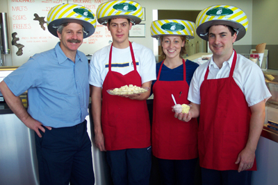 A photo of four creamery workers with ice cream