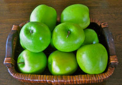 Photo of a bin of apples.