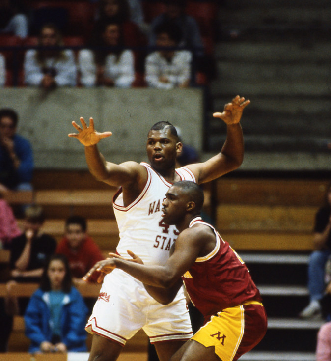 Image of two basketball players in action on court, one from WSU and one from Minnesota.