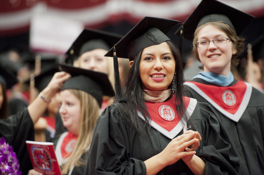 Image of a beautiful dark haired lady in her graduation regalia. with WSU stole.