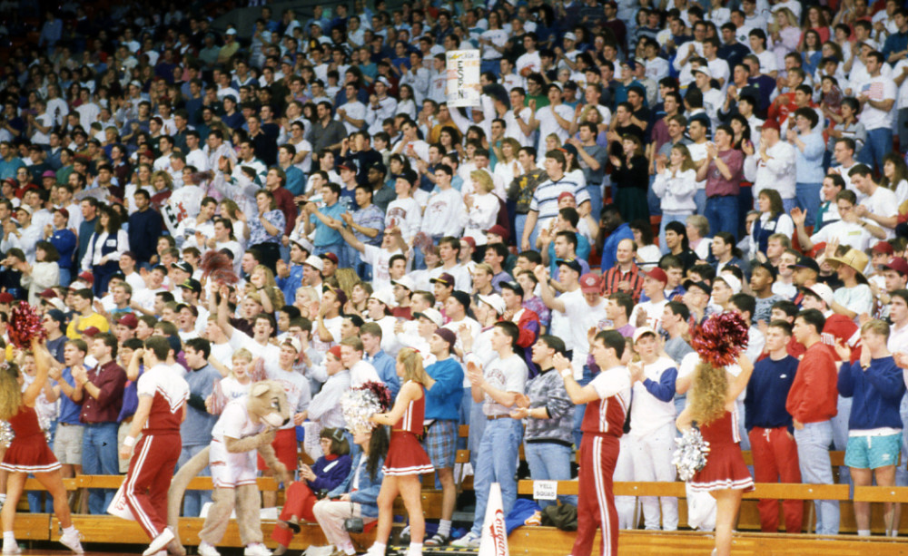Crowd shot at a basketball game/ Cheerleaders on the court.