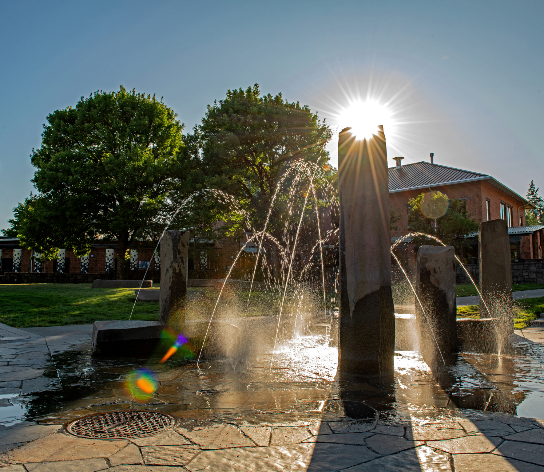 A backlit photo of the stone fountain on the WSU Vancouver campus