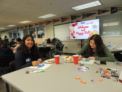 Students filling in their About Me paper dolls for an activity at the 2022 Fall Social.