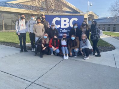 Group photo in front of Columbia Basin College banner while on 2021 CBC campus trip.