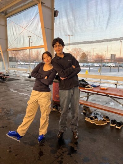 Two students posing together at the Moses Lake Ice Rink cultural trip in 2023.