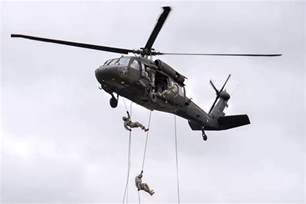 Cadets rappelling out of a helicopter.