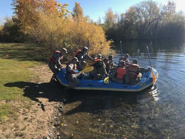 A group of WSU Army ROTC in a paddle boat on the river.