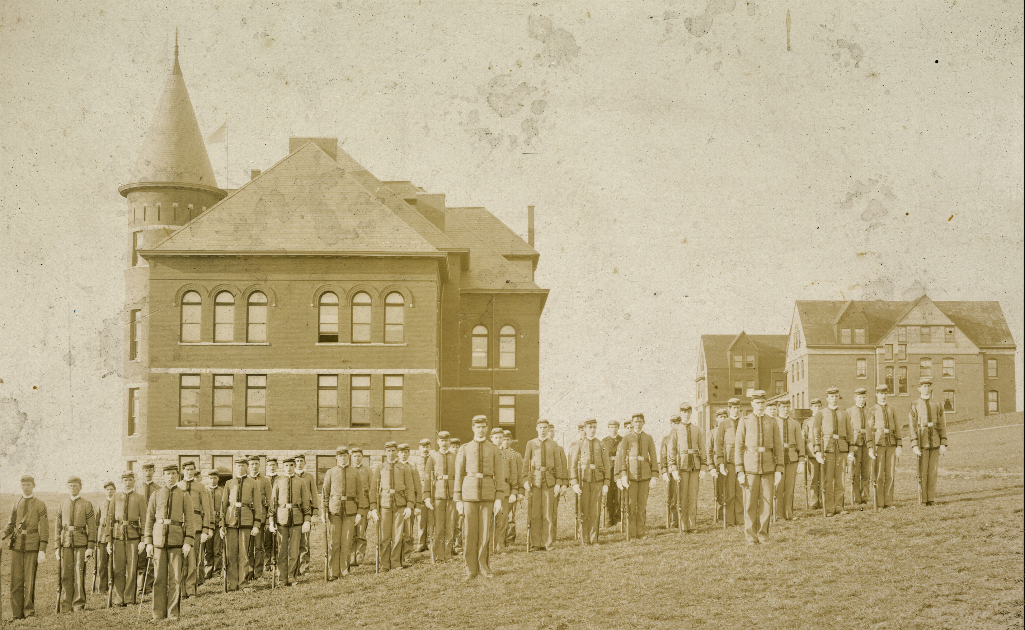 An early 20 century photos of cadets lined up in formation near Thompson Hall.