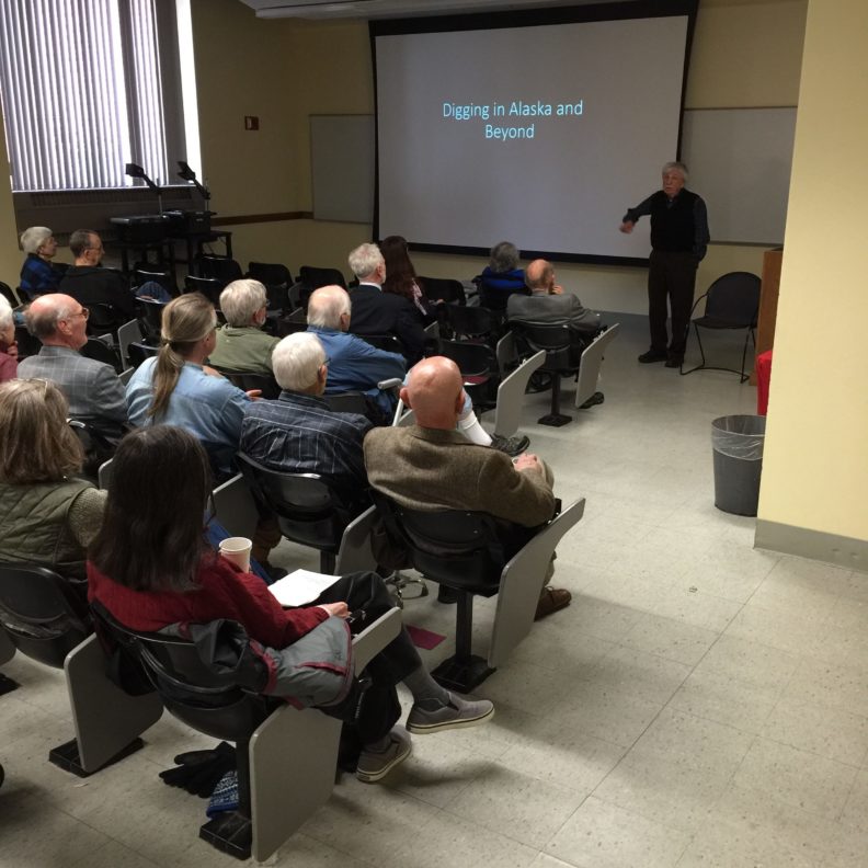 Robert Ackerman stands at the front of a classroom to begin his presentation.