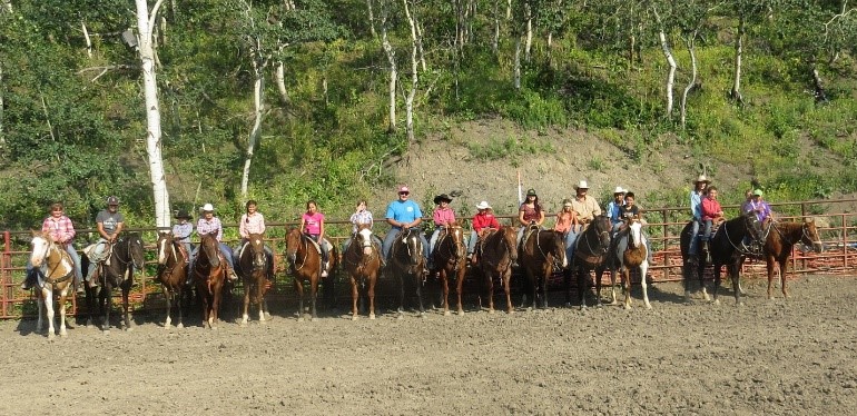 Horseback riders in a line.