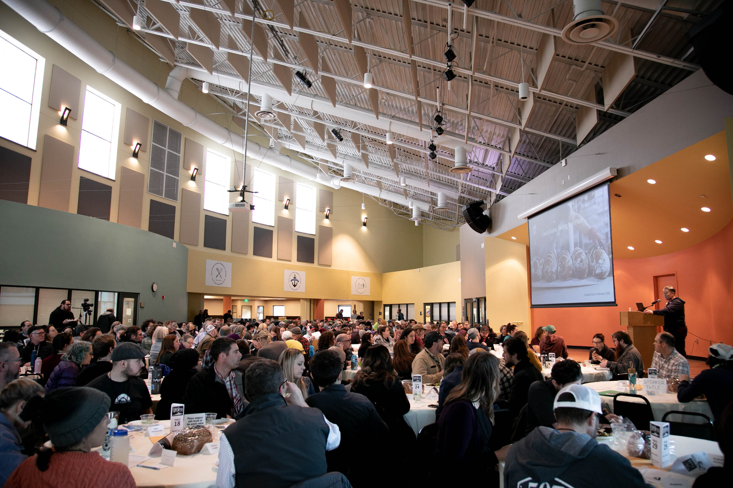 Mel Darbyshire speaking at a podium as the keynote speaker for Cascadia Grains 2019.