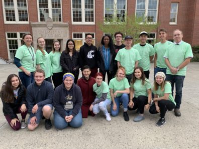 A group of smiling people in matching tshirts.