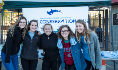 group of students in front of sign