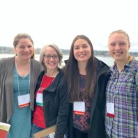 photo of 4 scientists at conference