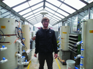 Geologist surrounded by laboratory equipment.