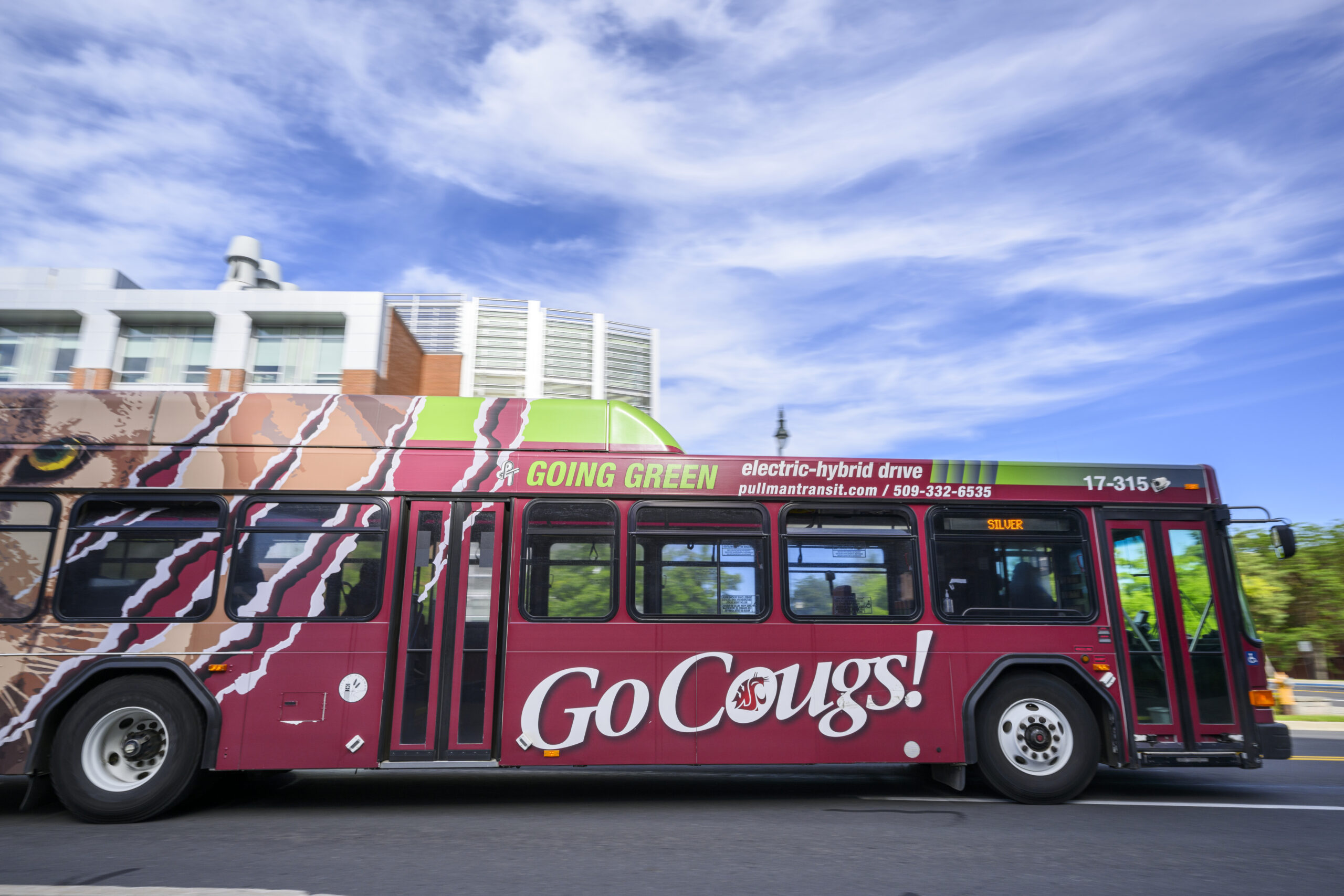 A Pullman Transit bus with large "Go Cougs!" on the side.