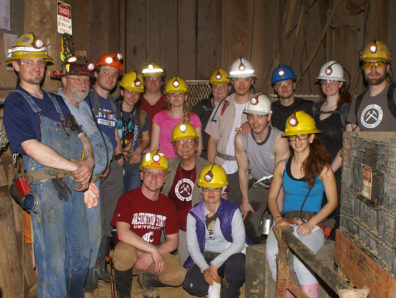 SOE students wearing hard hats with headlamps. 