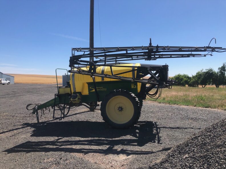 Sprayer sitting in a yard.