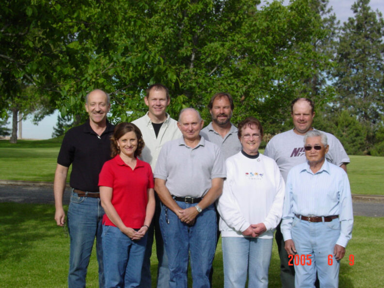 People standing in front of a tree. 