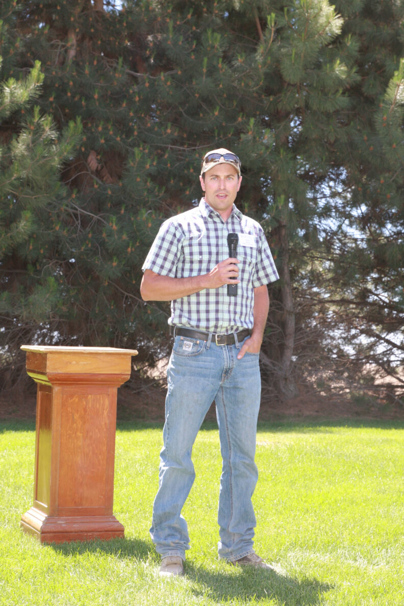 Josh Knodel standing with a microphone.