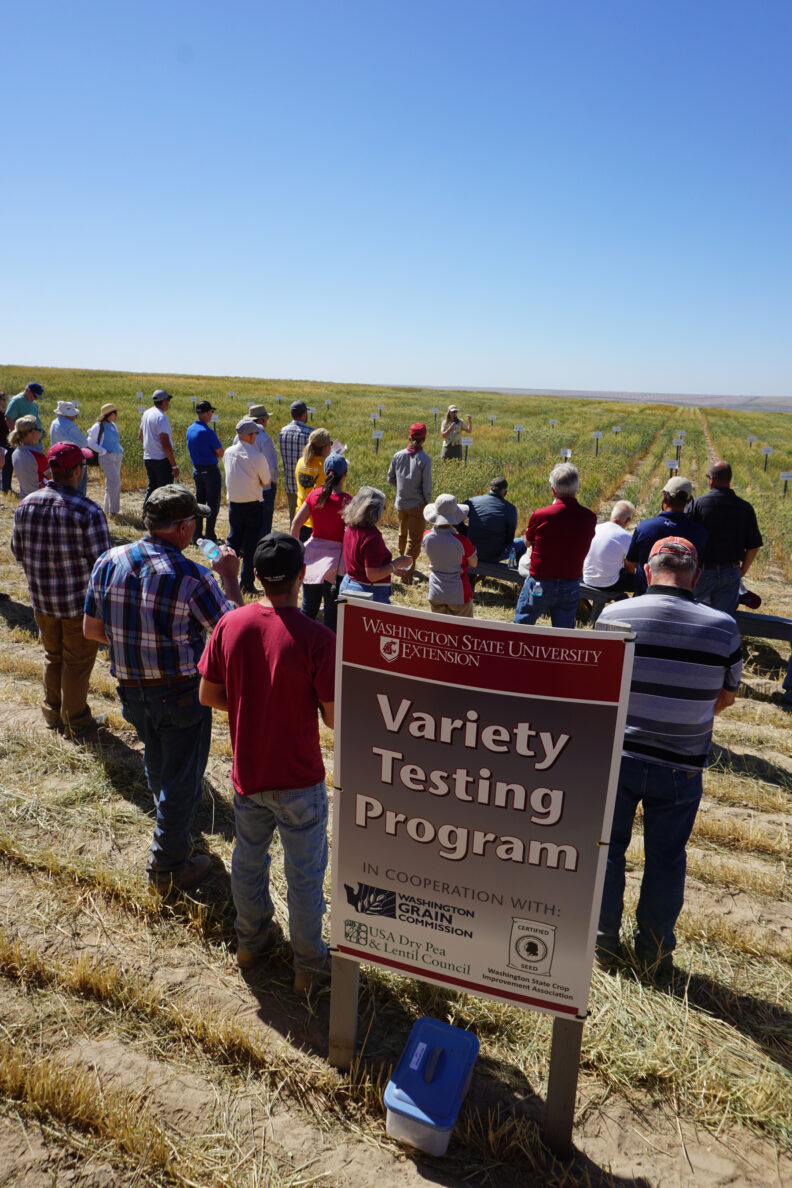 Attendees standing next to the Variety Breeding sign.