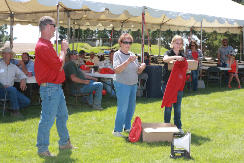 Aaron Esser, Gladie Nagamitsu, and Samantha Crow picking a raffle.