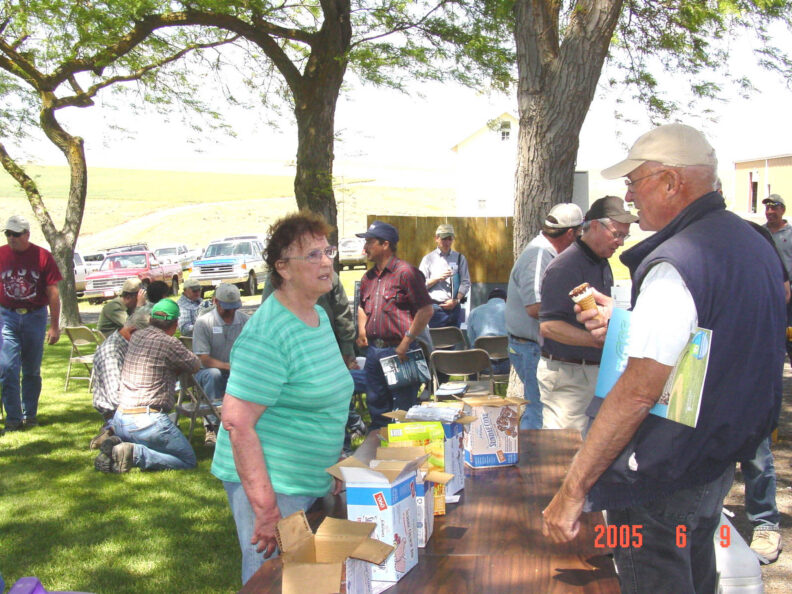 People around a table with ice cream.