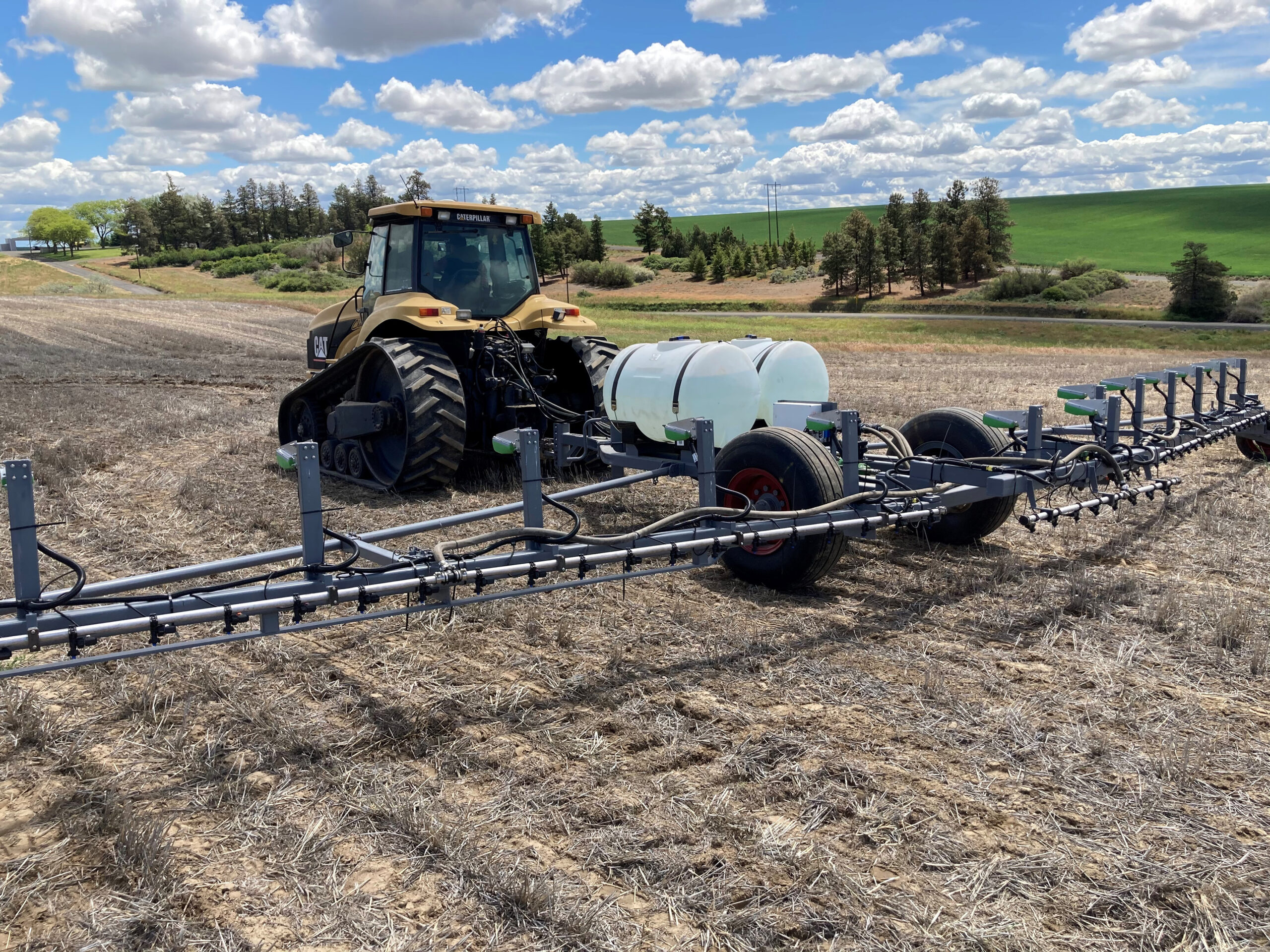 Weed-It sprayer pulled behind a tractor.