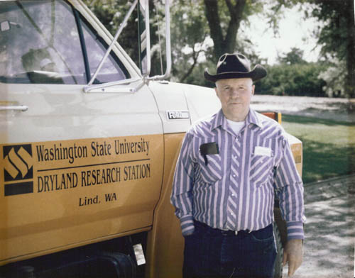 Man standing next to a truck.
