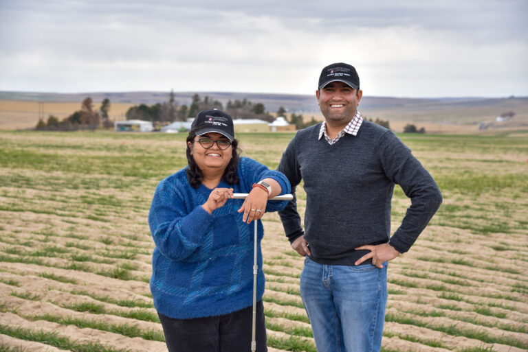 Shikha and Surendra in a field.
