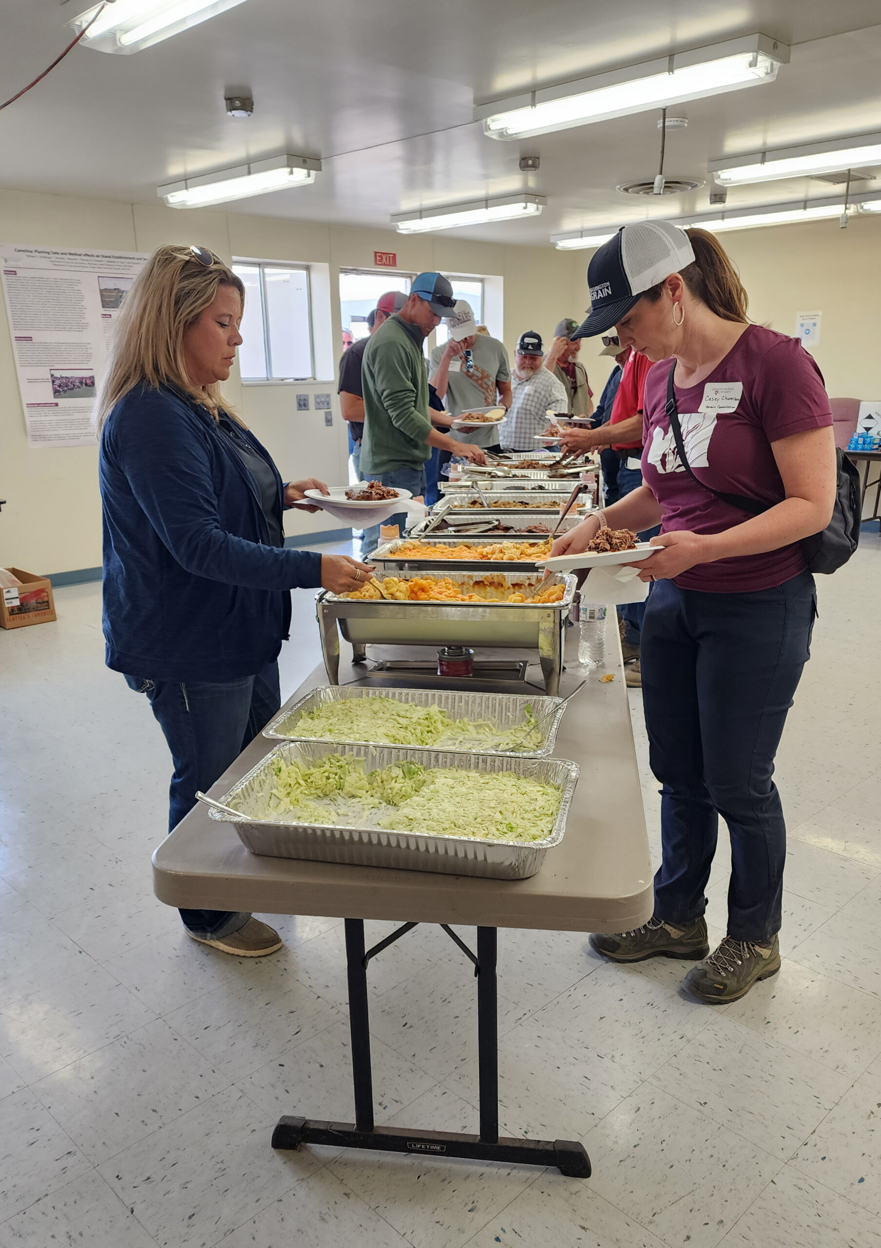 People dishing up food.