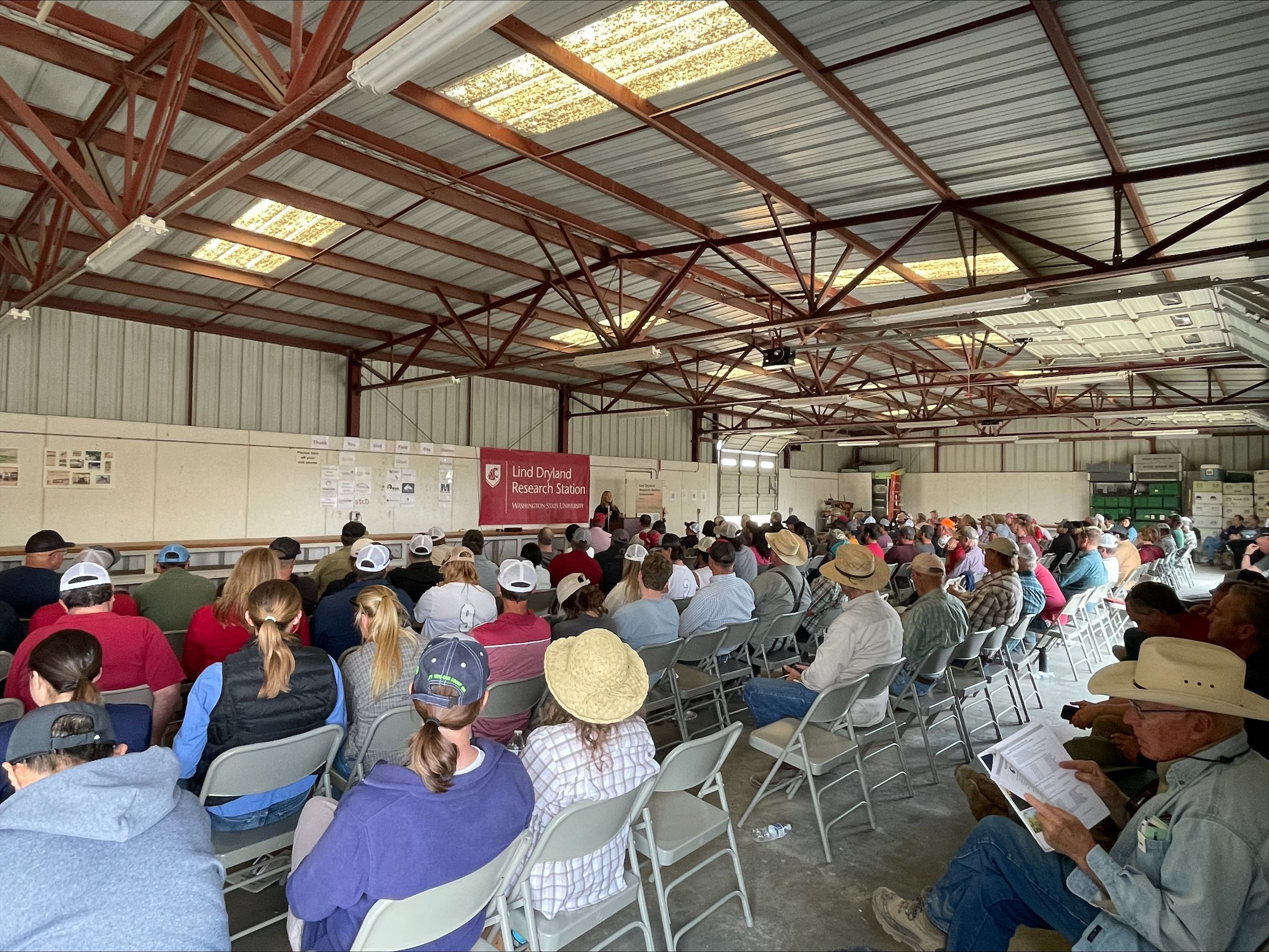 People sitting in chairs listening to a presenter.