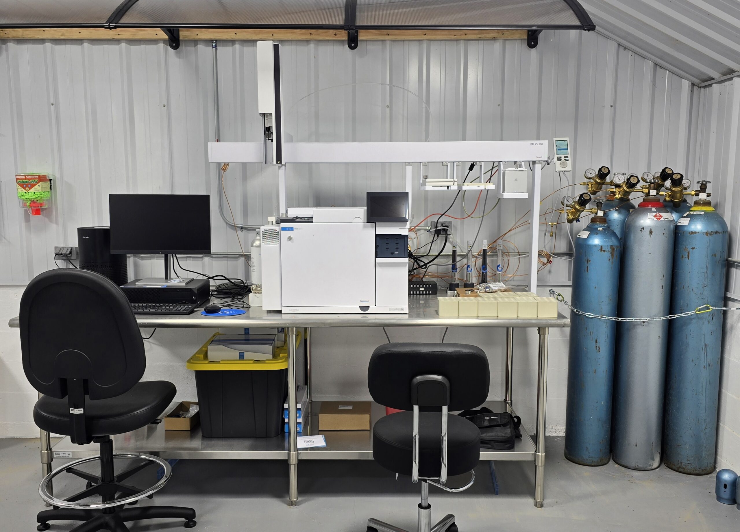 Agilent Gas Chromatograph on a table with chairs.