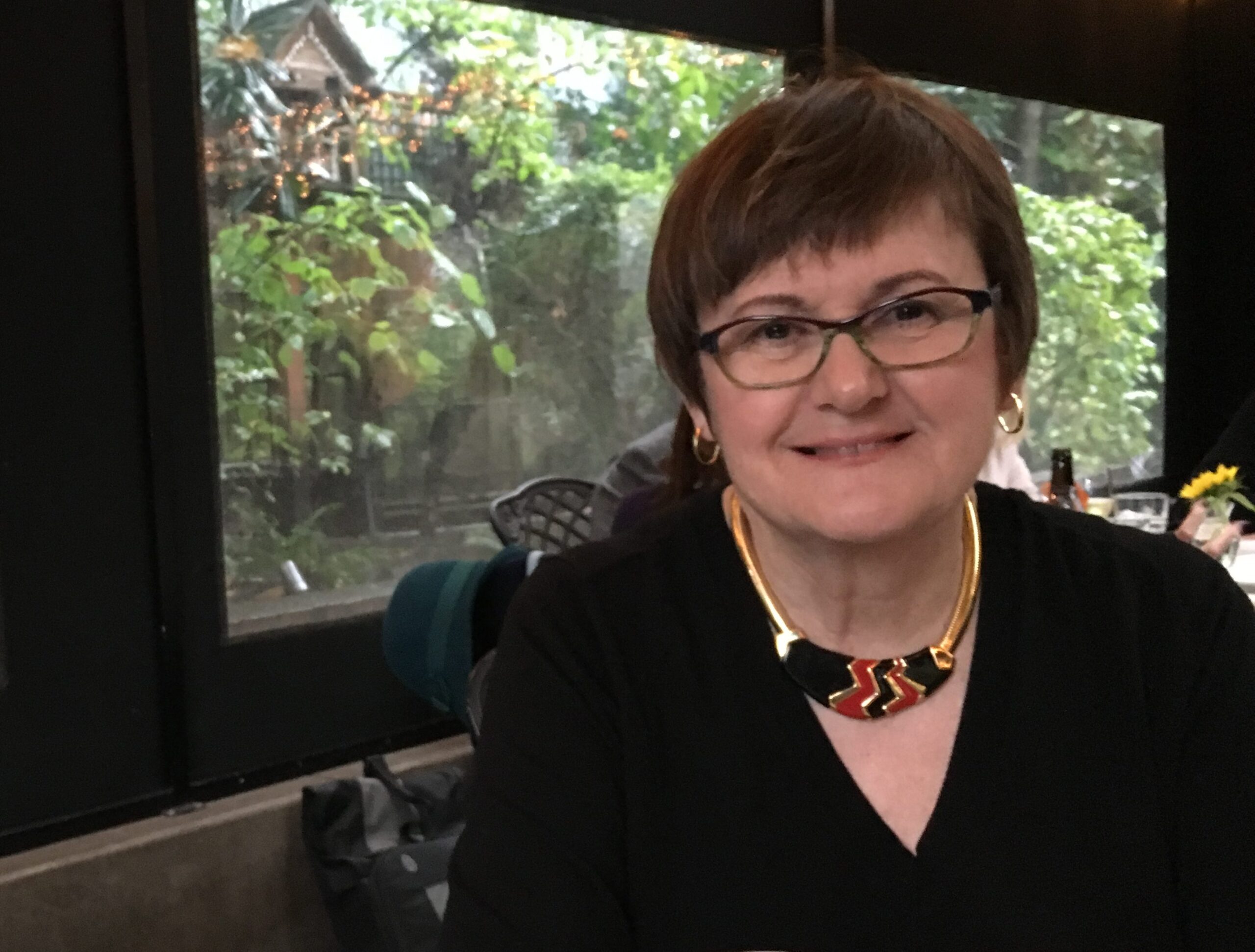 Photo of Candace Wellman seated in front of a window