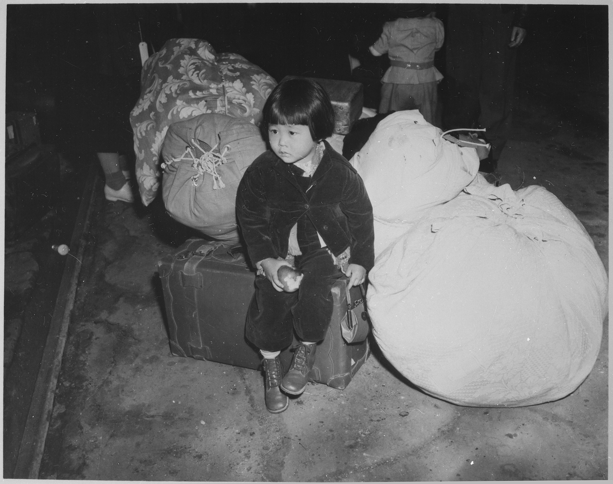 photo of Japanese American girl waiting with baggage