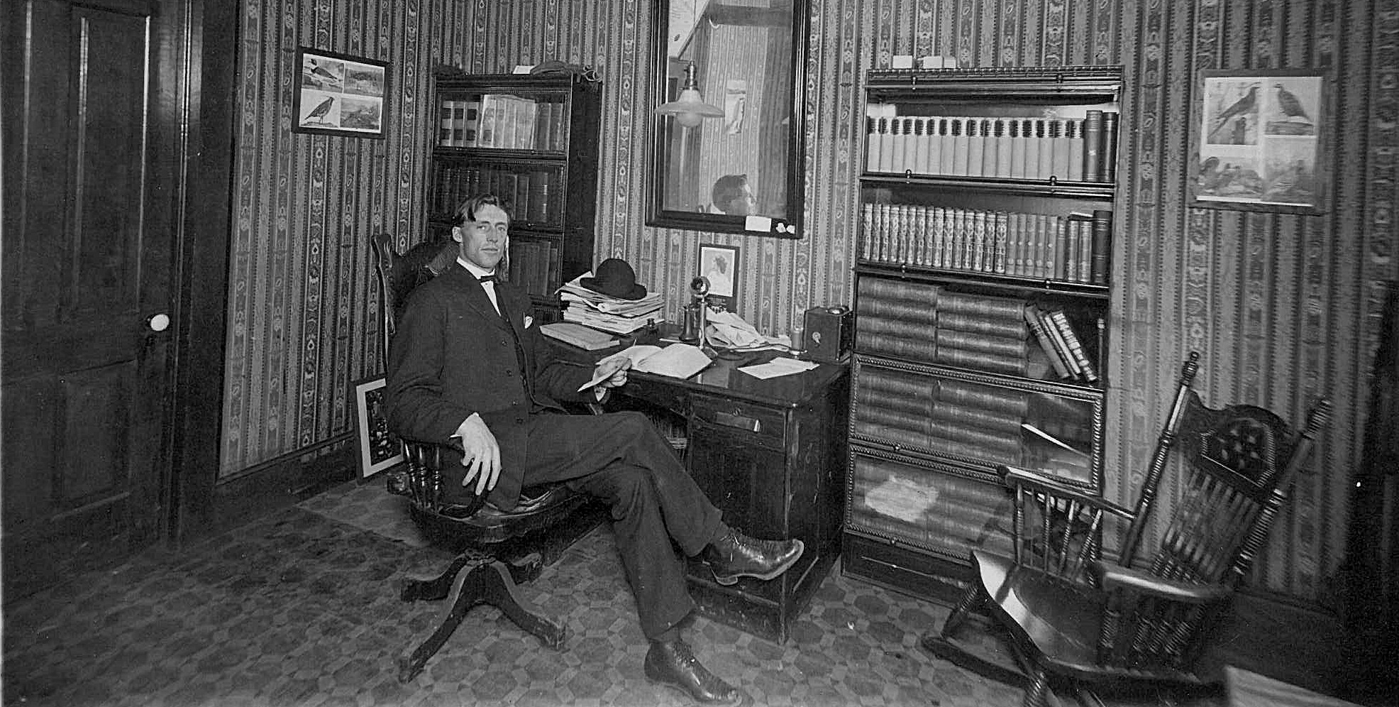 photo of Doc Wright sitting at a desk n his office, circa 1906