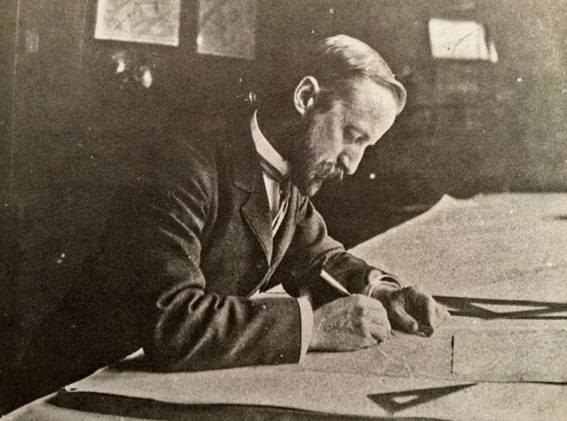 Photo of John Charles Olmsted working at his desk