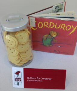 Book entry for Corduroy, with a jar of button-shaped cookies and entry placard