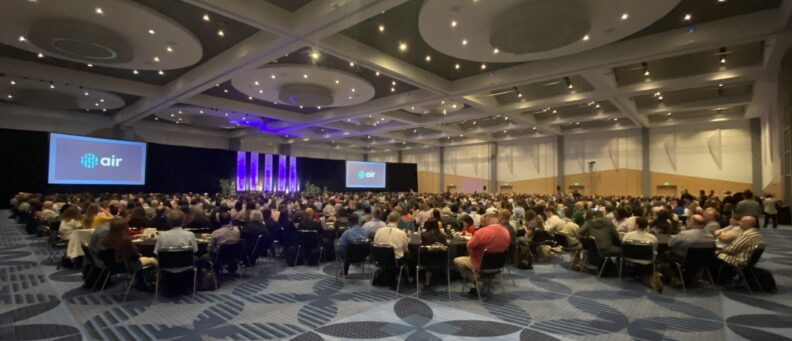 people sitting at tables in the air forum conference