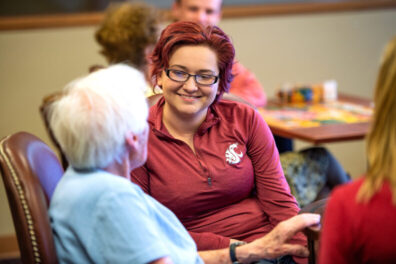 Student talking with someone in an elderly care facility