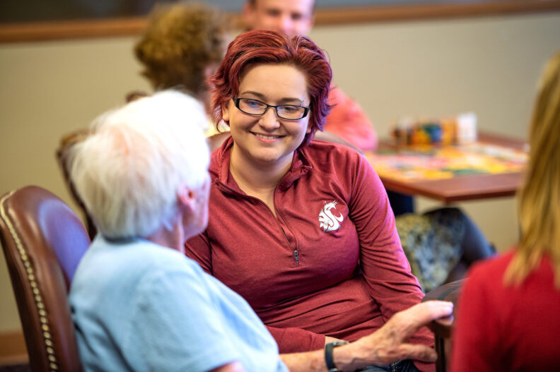 Student talking with someone in an elderly care facility